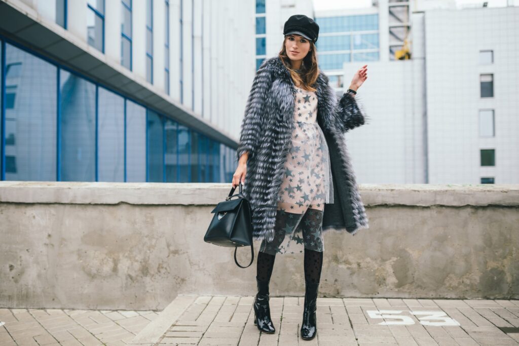 stylish woman in winter fur coat walking in street