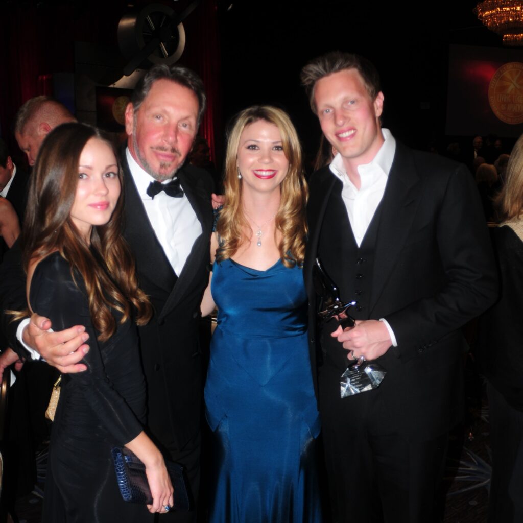 Billionaire Larry Ellison Watches Son David Receiv